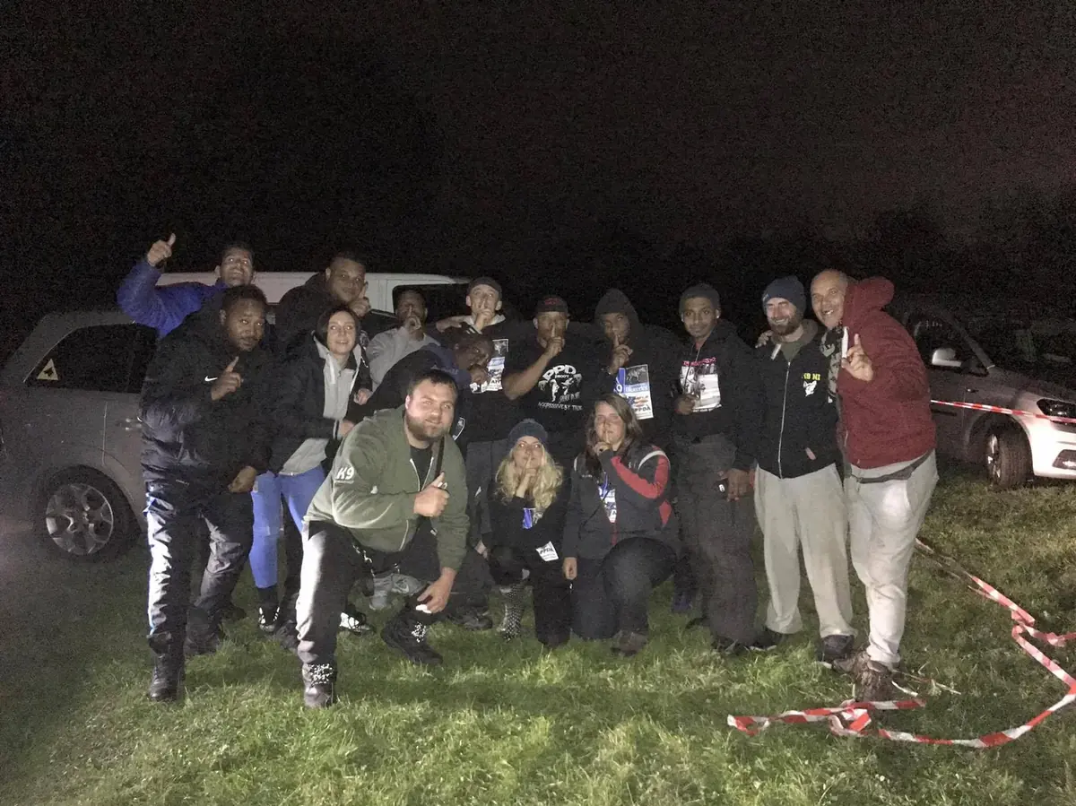 Jeremy with trainers and handlers after an evening training session